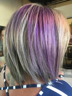 Woman with purple hair color highlight